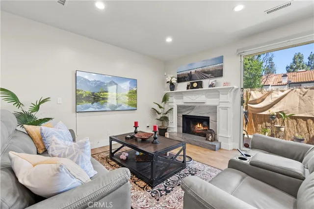 a living room with furniture a window and a fireplace