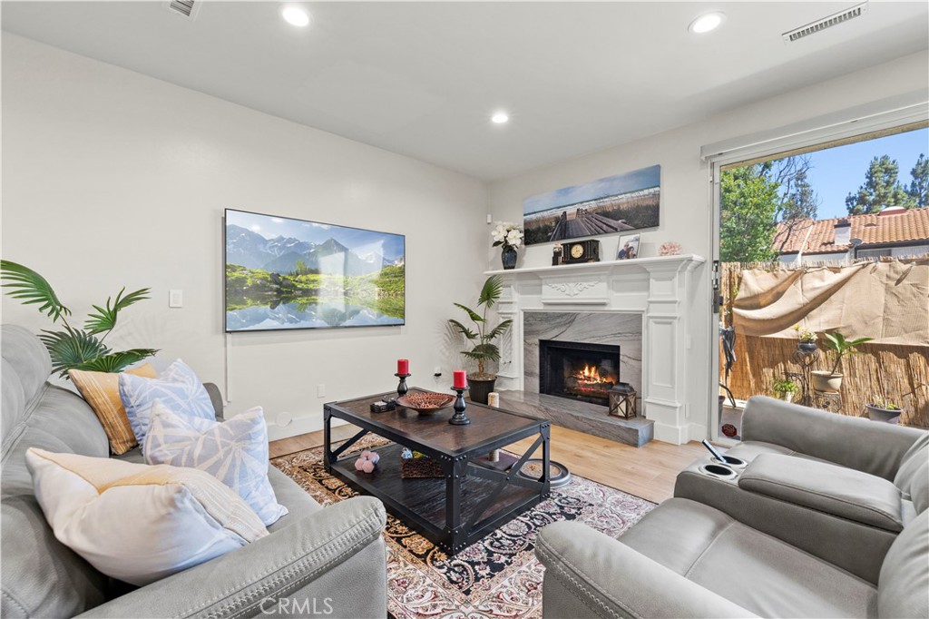 5602 Las Virgenes Road, Unit 79 Calabasas, CA 91302 - Photo 12 of 56 a living room with furniture a window and a fireplace