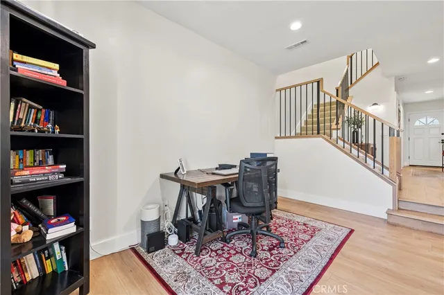 a bathroom with a granite countertop sink a toilet and a mirror
