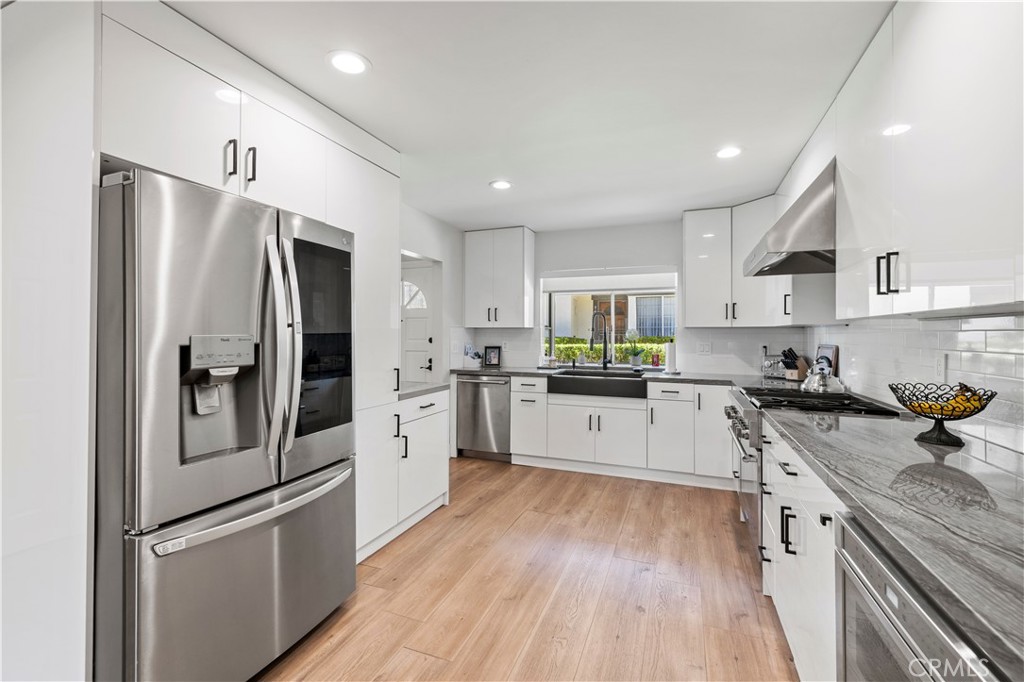 5602 Las Virgenes Road, Unit 79 Calabasas, CA 91302 - Photo 2 of 56 a kitchen with stainless steel appliances a refrigerator a sink and white cabinets