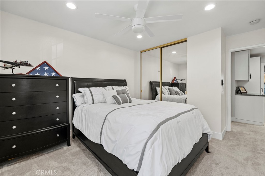 5602 Las Virgenes Road, Unit 79 Calabasas, CA 91302 - Photo 26 of 56 a bedroom with a bed and a chandelier