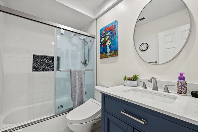a kitchen with a refrigerator and white cabinets