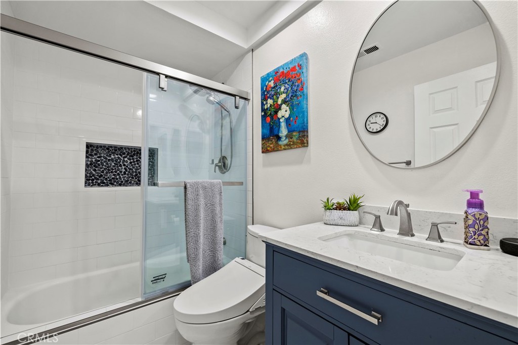 5602 Las Virgenes Road, Unit 79 Calabasas, CA 91302 - Photo 27 of 56 a bathroom with a granite countertop sink mirror vanity and toilet