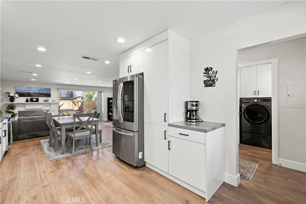 5602 Las Virgenes Road, Unit 79 Calabasas, CA 91302 - Photo 3 of 56 a kitchen with a table chairs refrigerator and cabinets