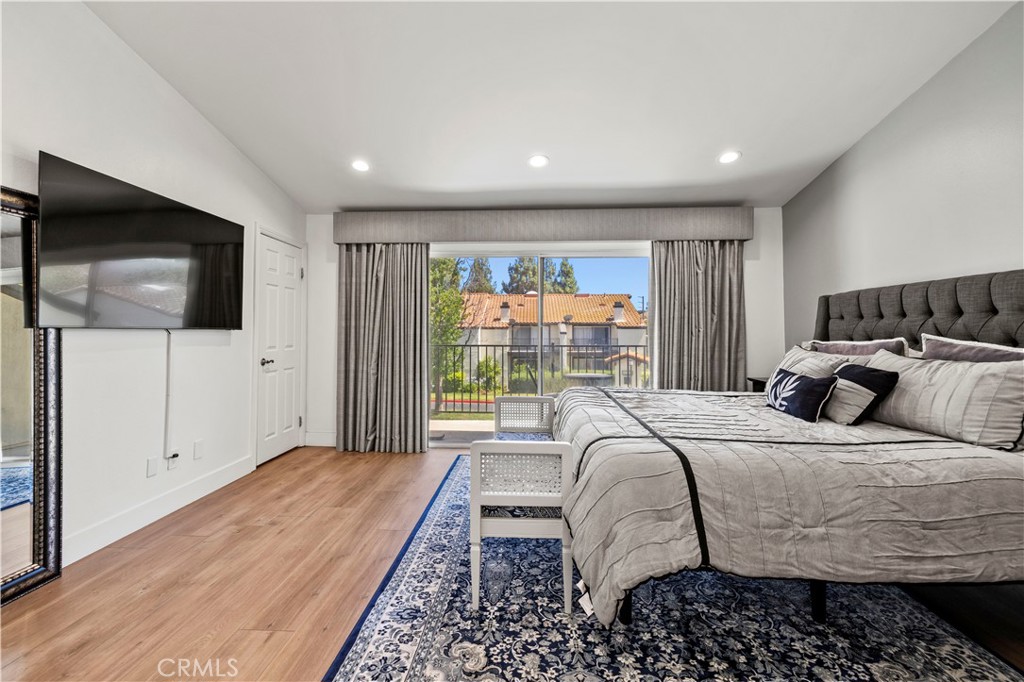 5602 Las Virgenes Road, Unit 79 Calabasas, CA 91302 - Photo 31 of 56 a bedroom with a bed and a flat screen tv