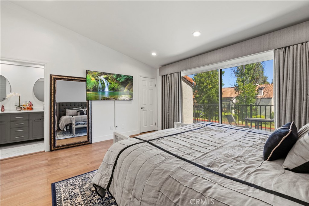 5602 Las Virgenes Road, Unit 79 Calabasas, CA 91302 - Photo 32 of 56 a bedroom with a bed a dresser and a large window