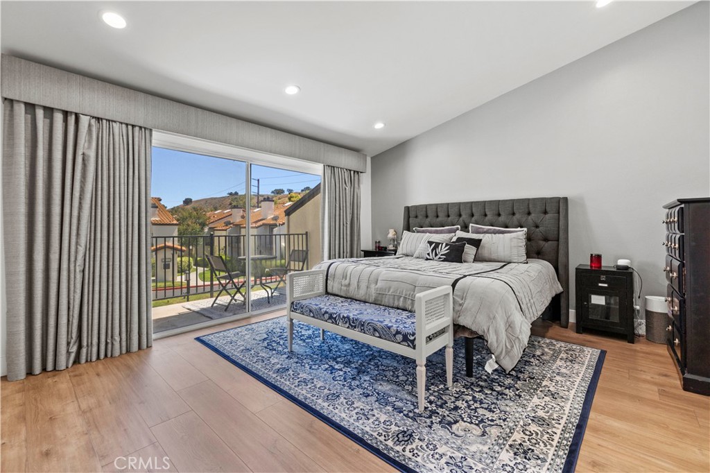 5602 Las Virgenes Road, Unit 79 Calabasas, CA 91302 - Photo 33 of 56 a bedroom with a bed and wooden floor