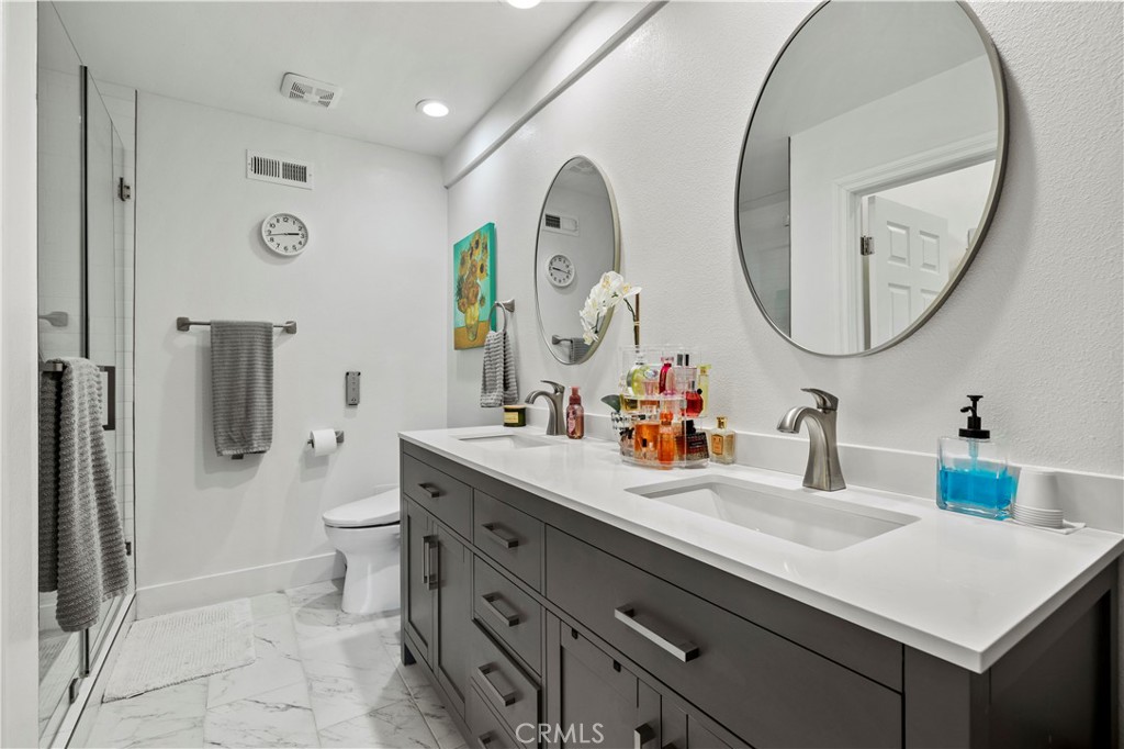 5602 Las Virgenes Road, Unit 79 Calabasas, CA 91302 - Photo 36 of 56 a bathroom with a sink mirror toilet and a shower