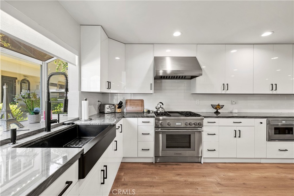 5602 Las Virgenes Road, Unit 79 Calabasas, CA 91302 - Photo 6 of 56 a kitchen with stainless steel appliances granite countertop a stove a sink and a granite counter tops