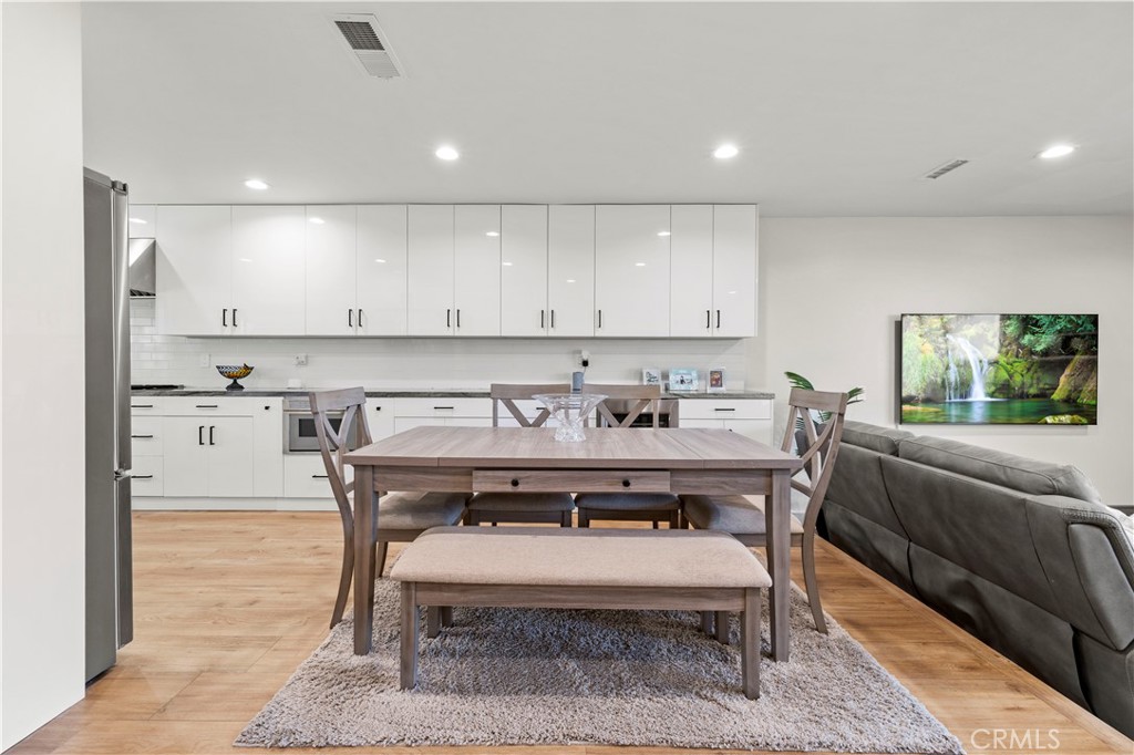 5602 Las Virgenes Road, Unit 79 Calabasas, CA 91302 - Photo 9 of 56 a view of a kitchen with kitchen island a dining table and chairs