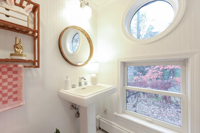 a room with furniture a lamp wooden floor and a window