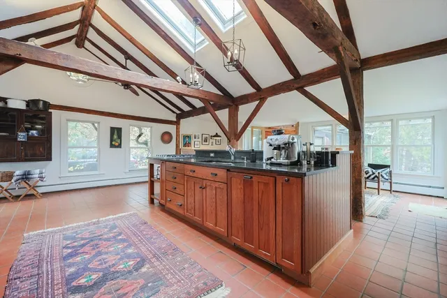a living room with furniture a rug and a large window