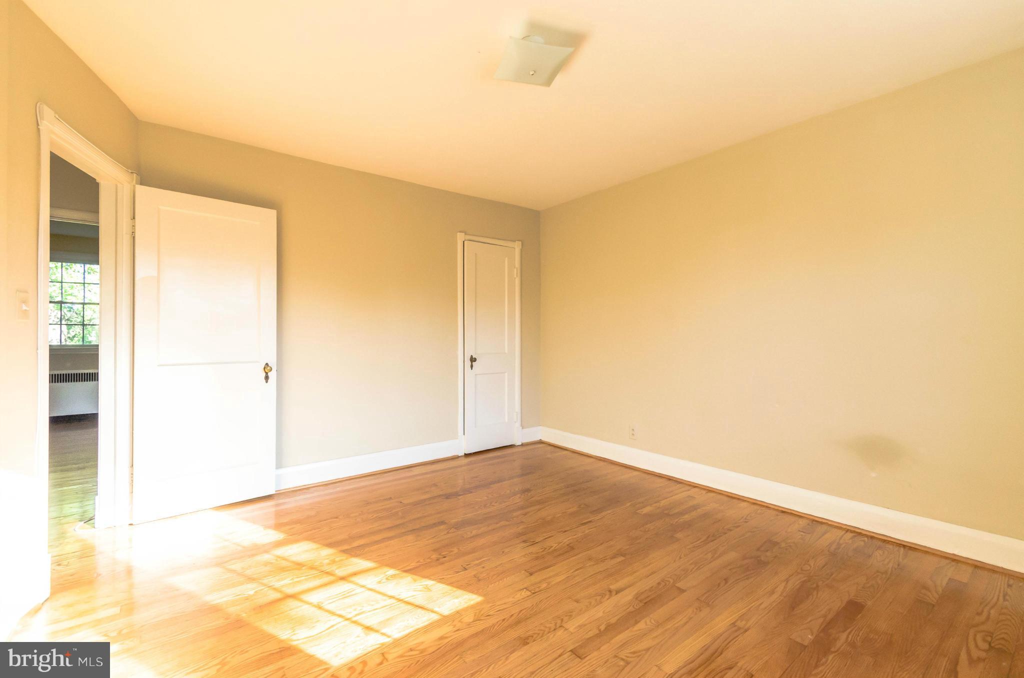 10 Murdock Road Baltimore, MD 21212 - Photo 11 of 26 an empty room with wooden floor and windows