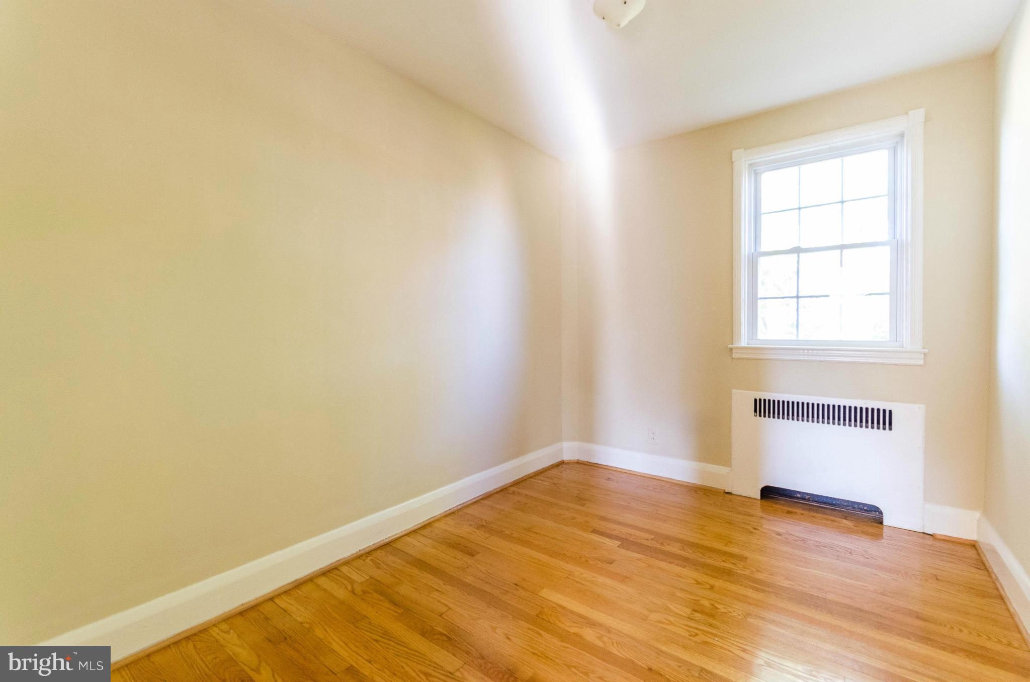 10 Murdock Road Baltimore, MD 21212 - Photo 15 of 26 an empty room with wooden floor and windows