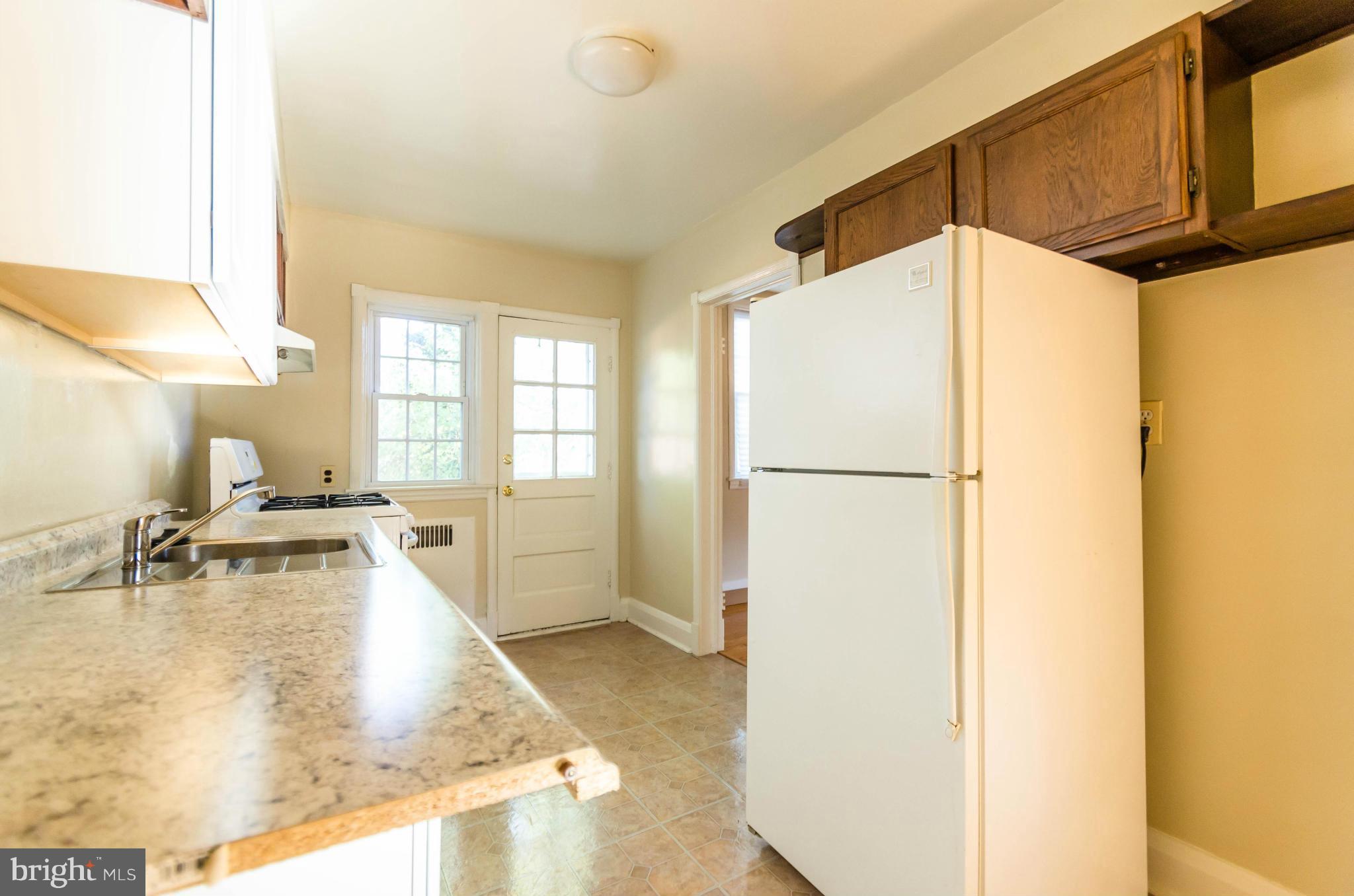 10 Murdock Road Baltimore, MD 21212 - Photo 6 of 26 a kitchen with a refrigerator and a sink
