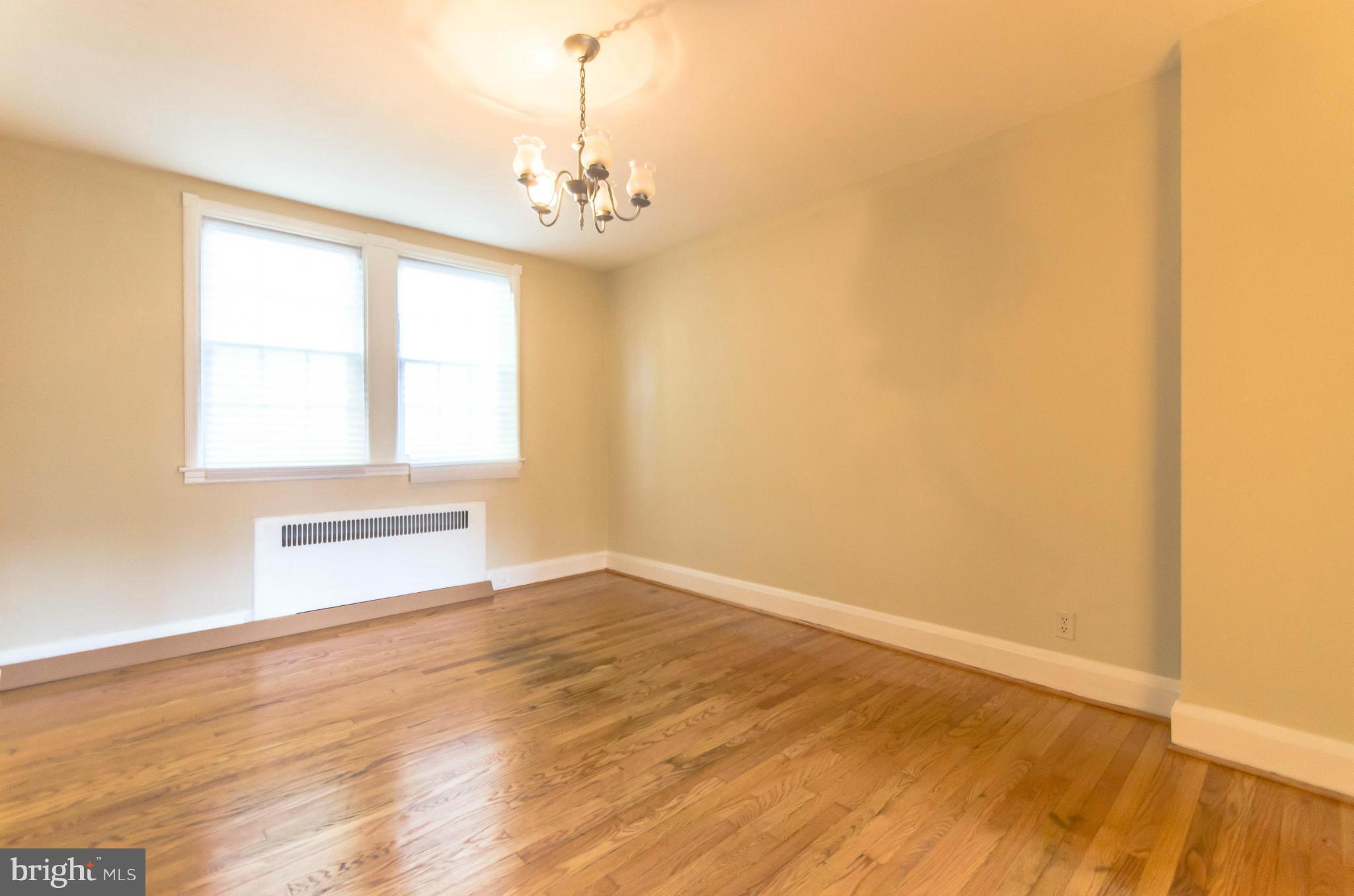 10 Murdock Road Baltimore, MD 21212 - Photo 7 of 26 a view of an empty room with wooden floor and a window
