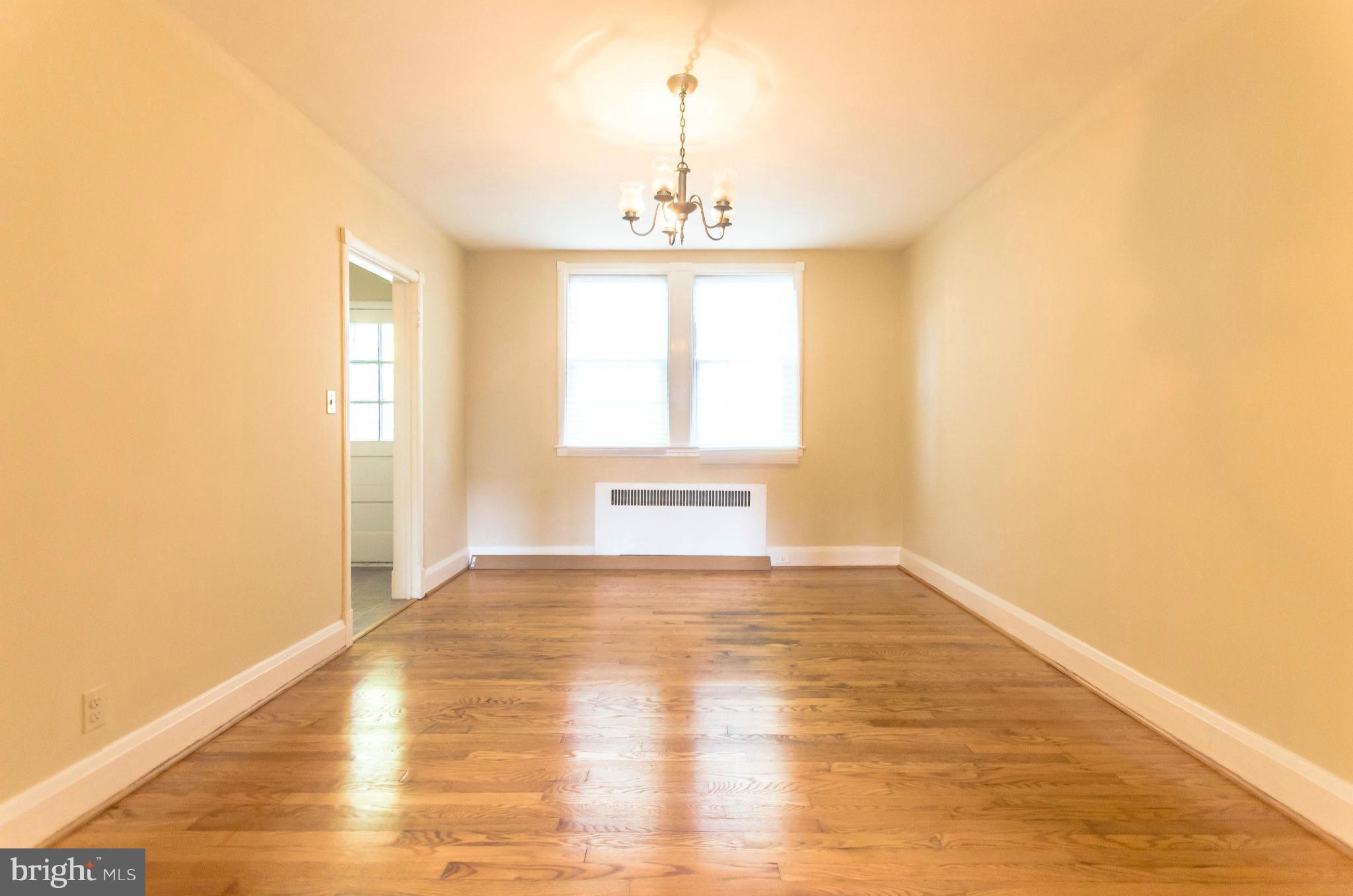 10 Murdock Road Baltimore, MD 21212 - Photo 8 of 26 a view of an empty room with wooden floor and a window
