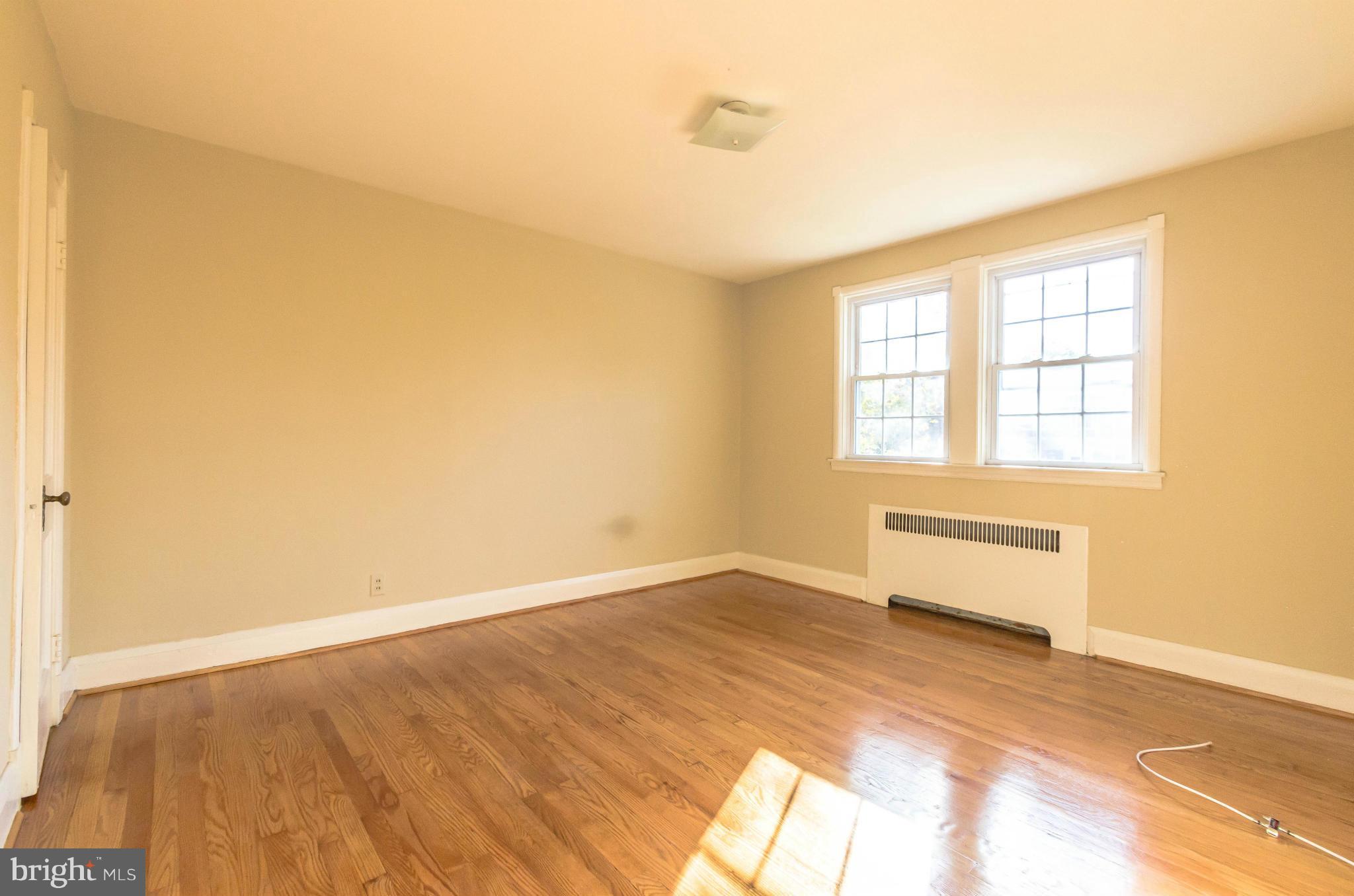 10 Murdock Road Baltimore, MD 21212 - Photo 10 of 26 an empty room with wooden floor and windows