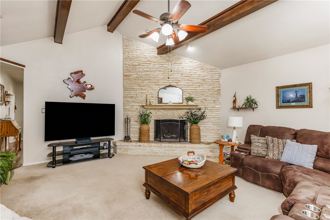 345 Trail Ridge Drive Sandia, TX 78383 - Photo 24 of 40 a living room with furniture a fireplace and a flat screen tv