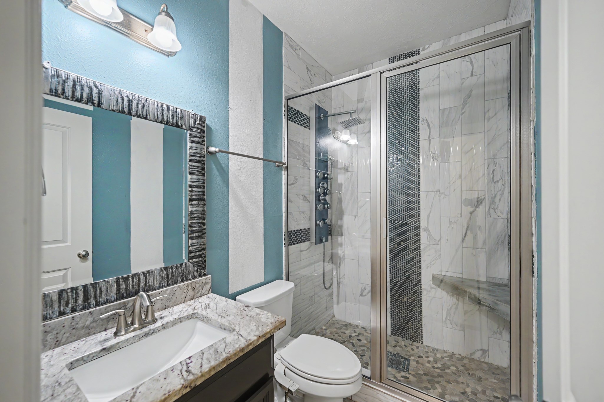 31325 Riley Woods Court Spring, TX 77386 - Photo 32 of 50 Upgraded bath features a custom tiled shower with multiple shower heads, built in bench and glass enclosure.