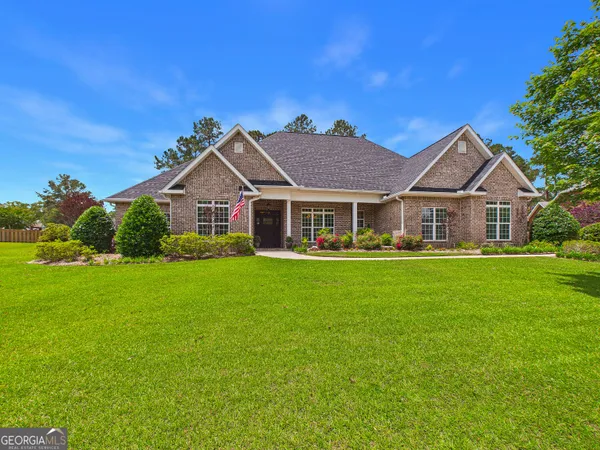 a front view of a house with a garden