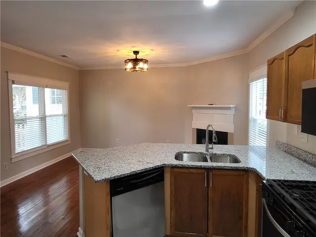 a kitchen with a sink a stove and cabinets