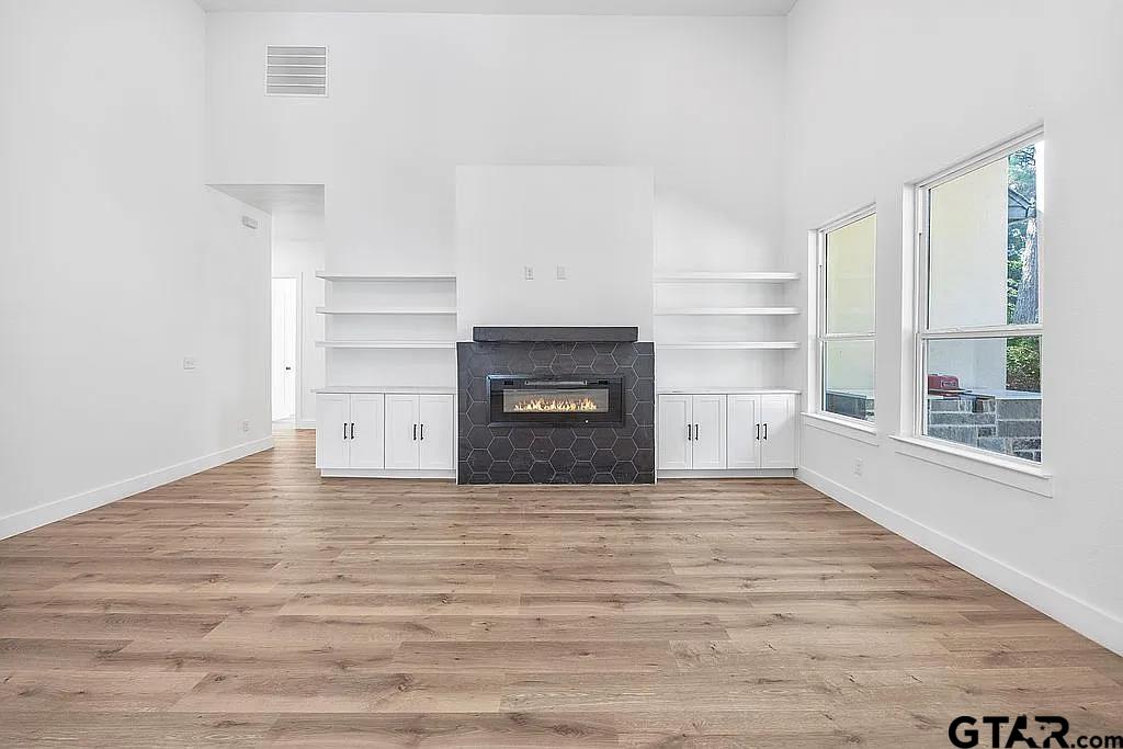 4504 Triggs Trace Tyler, TX 75709 - Photo 15 of 46 a view of an empty room with a fireplace and a window