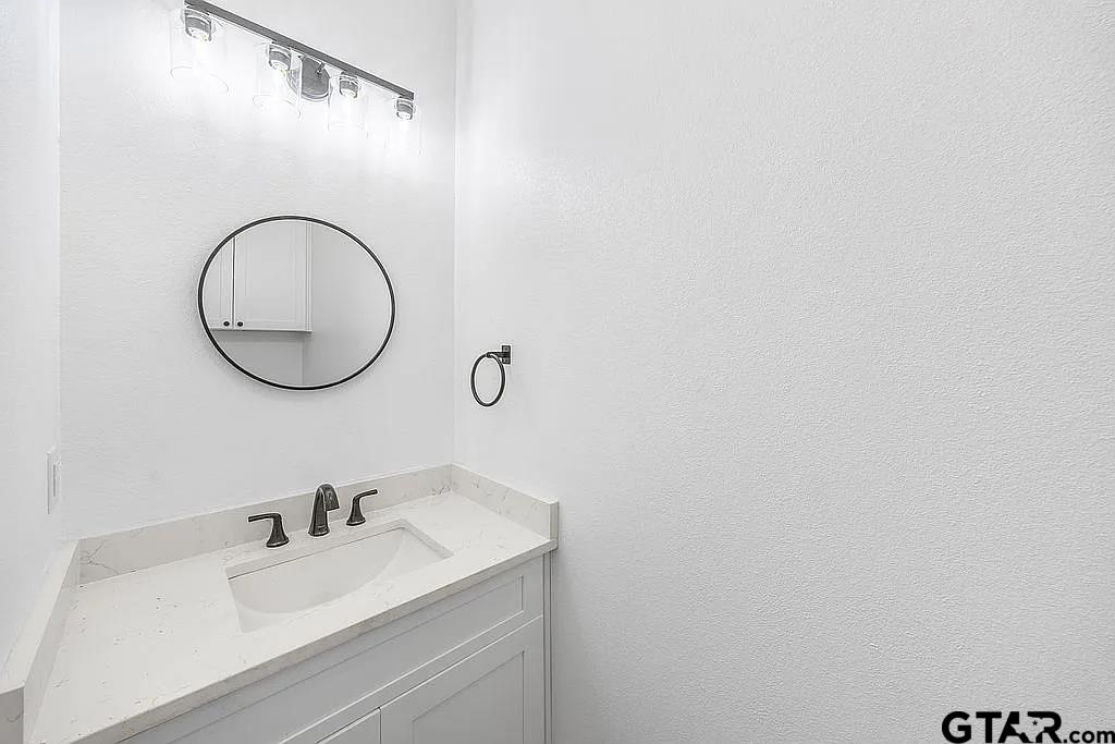 4504 Triggs Trace Tyler, TX 75709 - Photo 25 of 46 a bathroom with a sink and a mirror