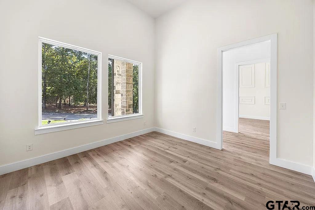 4504 Triggs Trace Tyler, TX 75709 - Photo 26 of 46 a view of an empty room with wooden floor and a window