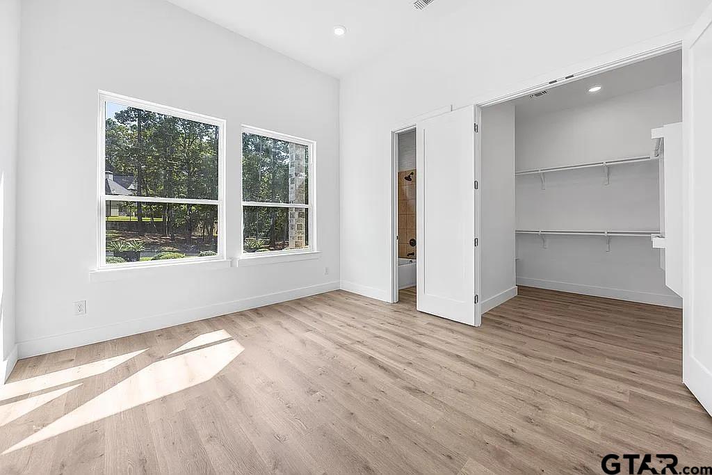 4504 Triggs Trace Tyler, TX 75709 - Photo 28 of 46 wooden floor in an empty room with a window