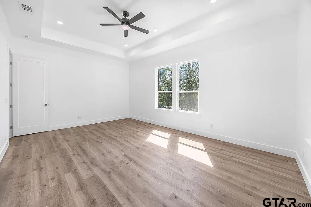 4504 Triggs Trace Tyler, TX 75709 - Photo 30 of 46 wooden floor in an empty room with a window