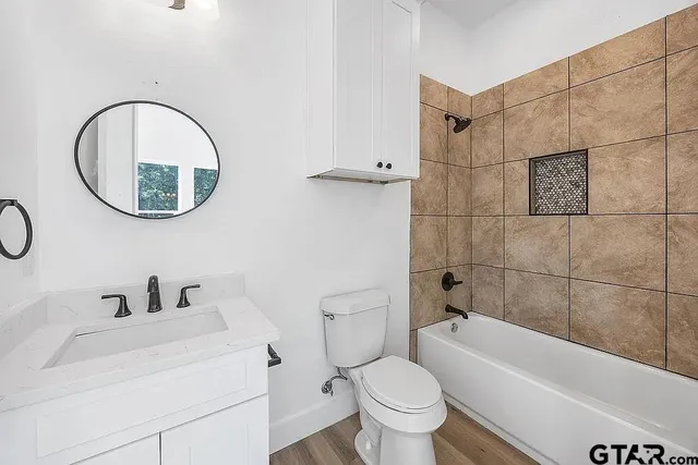 a bathroom with a sink a toilet and a bathtub