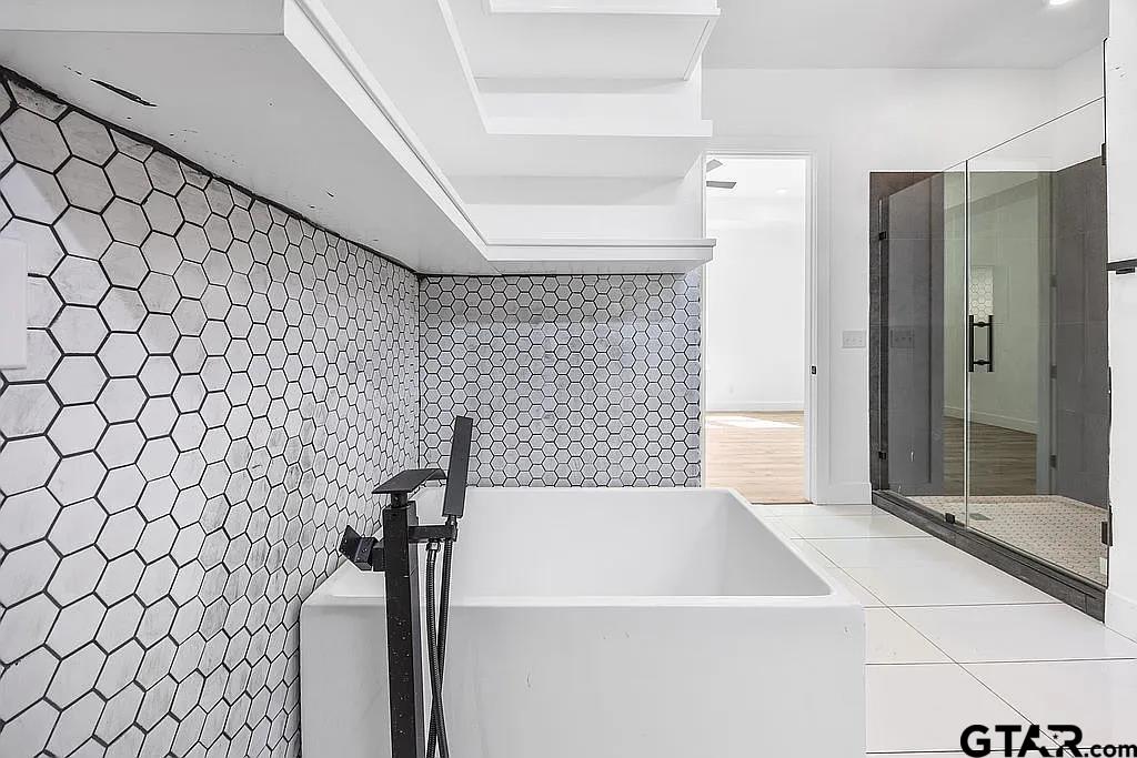 4504 Triggs Trace Tyler, TX 75709 - Photo 37 of 46 a bathroom with a bathtub and shower