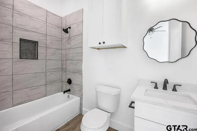 a bathroom with a toilet sink and bathtub