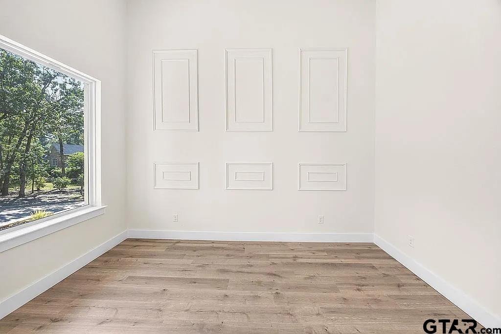 4504 Triggs Trace Tyler, TX 75709 - Photo 45 of 46 a view of an empty room with wooden floor and a window