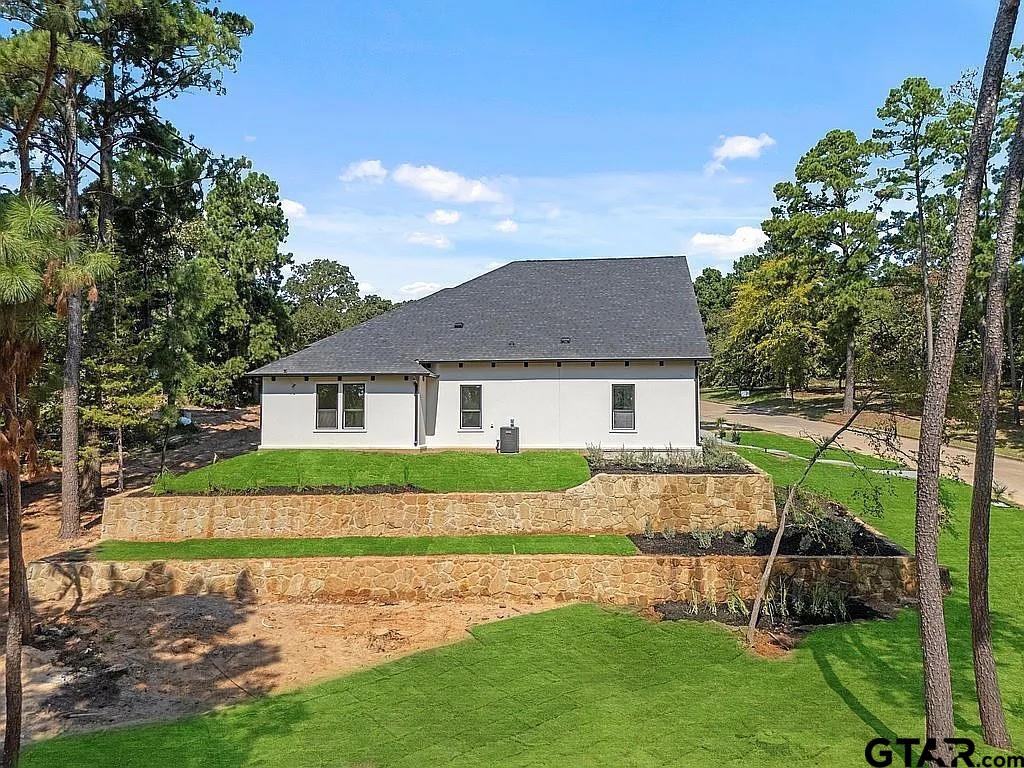 4504 Triggs Trace Tyler, TX 75709 - Photo 7 of 46 a front view of a house with a garden