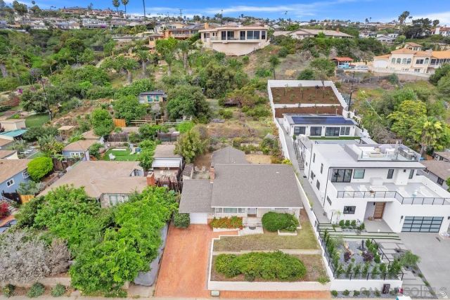 an aerial view of residential houses with outdoor space and street view