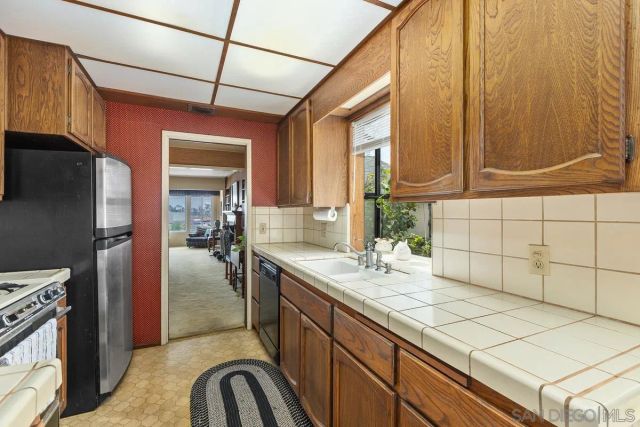 a kitchen with a sink cabinets and appliances