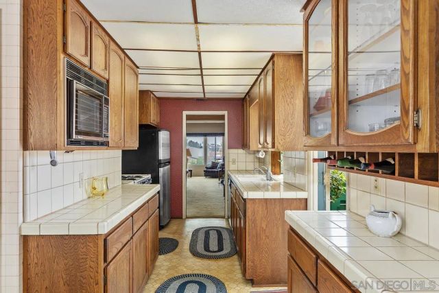 a kitchen with a sink a stove and a microwave
