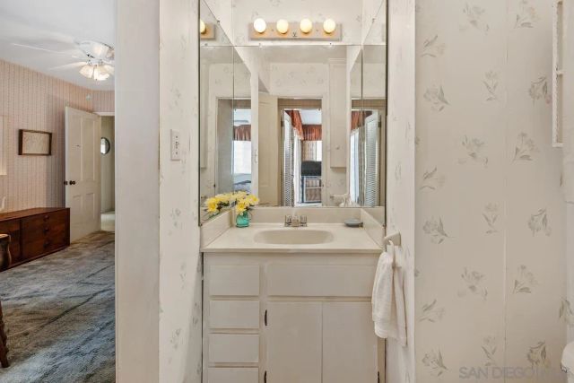 a en suite bathroom with a sink a mirror and a shower