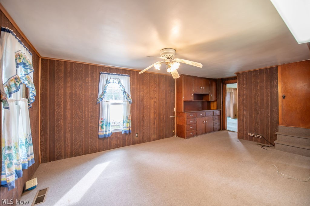 2468 Tabor Ridge Road Northeast New Philadelphia, OH 44663 - Photo 21 of 33 Open-concept dining area featuring ceiling fan and carpet flooring