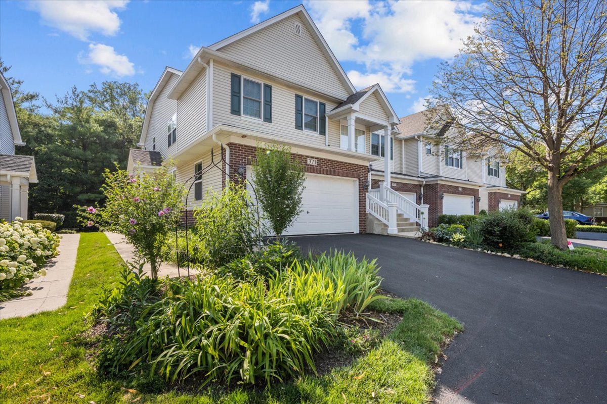 371 Ridge Road North Aurora, IL 60542 - Photo 1 of 21 a front view of a house with a yard