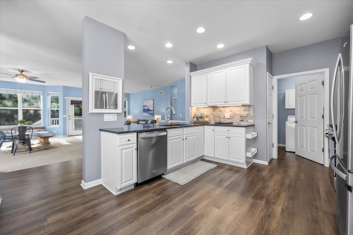 371 Ridge Road North Aurora, IL 60542 - Photo 8 of 21 a kitchen with stainless steel appliances granite countertop wooden floors refrigerator and cabinets