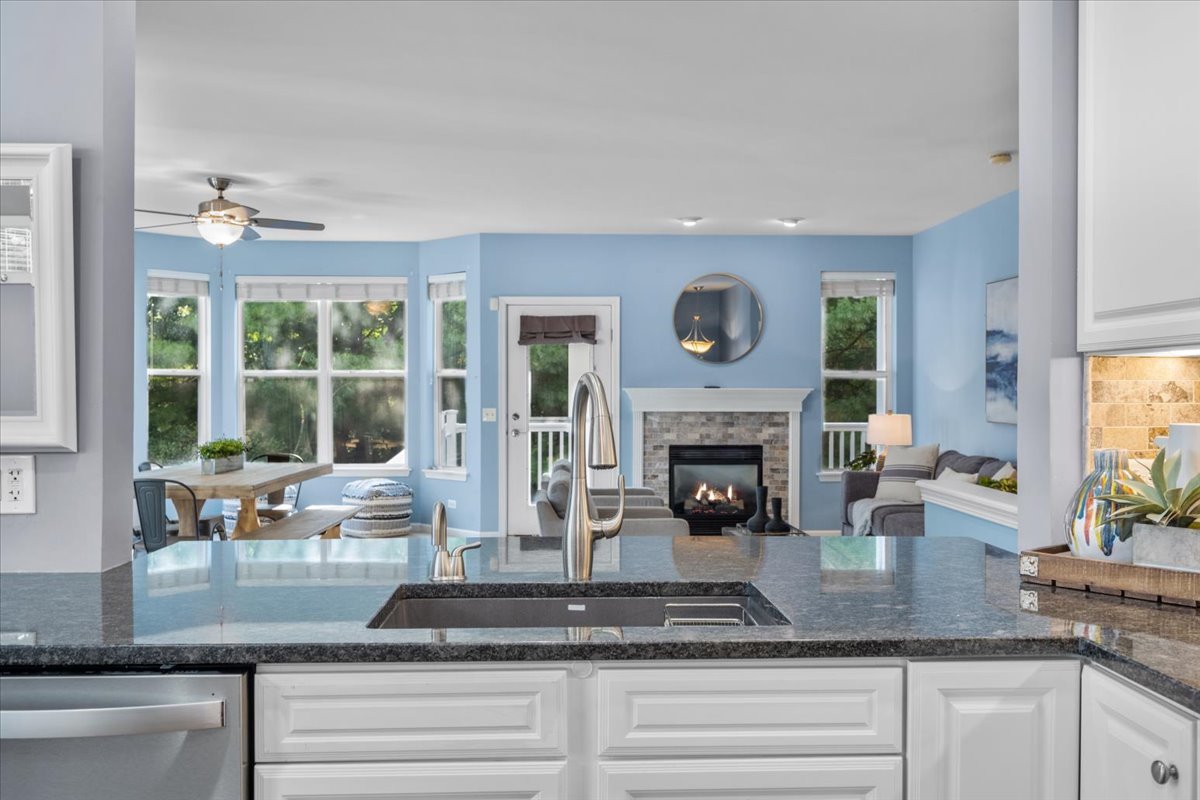 371 Ridge Road North Aurora, IL 60542 - Photo 10 of 21 a kitchen with granite countertop a fireplace and a large window