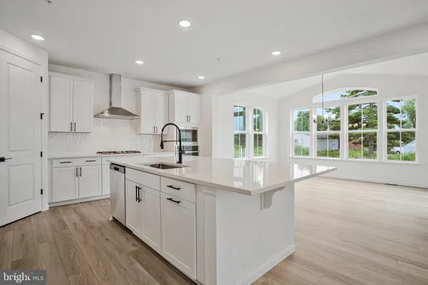 a view of a kitchen with wooden floor and a kitchen