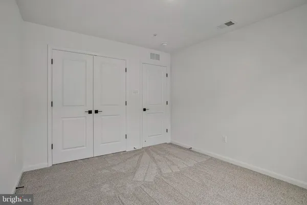 a bathroom with double sink and a mirror