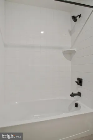 a bathroom with a tub and a shower