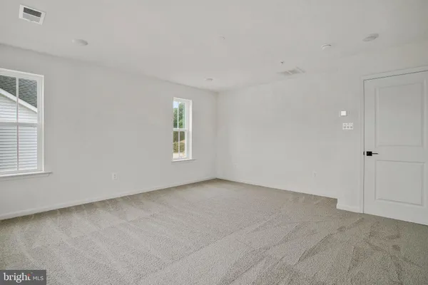 a bathroom with double sink and a mirror