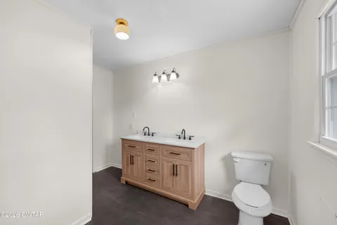 a bathroom with a double vanity sink and mirror