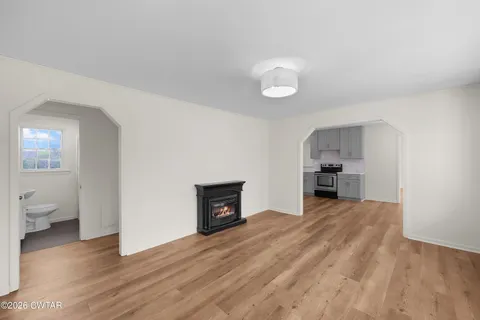 a view of livingroom with hardwood floor and a sink